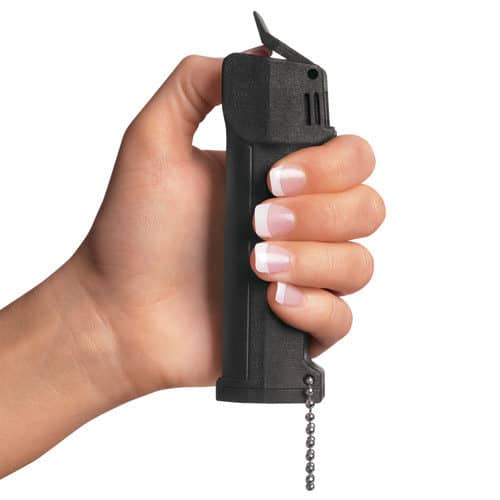 Mace triple action police pepper spray in ladys hand