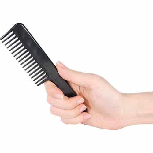 Black comb knife closed in hand