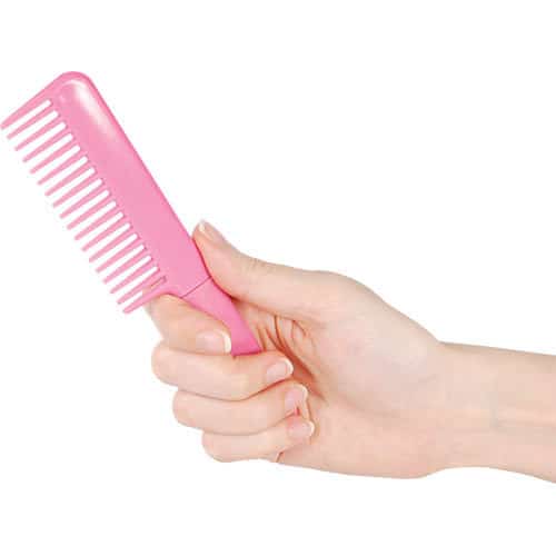 Pink comb knife closed in hand