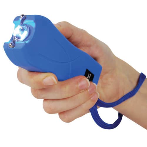 Blue runt stun gun in hand with flashlight on